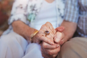 Elderly couple holding hands